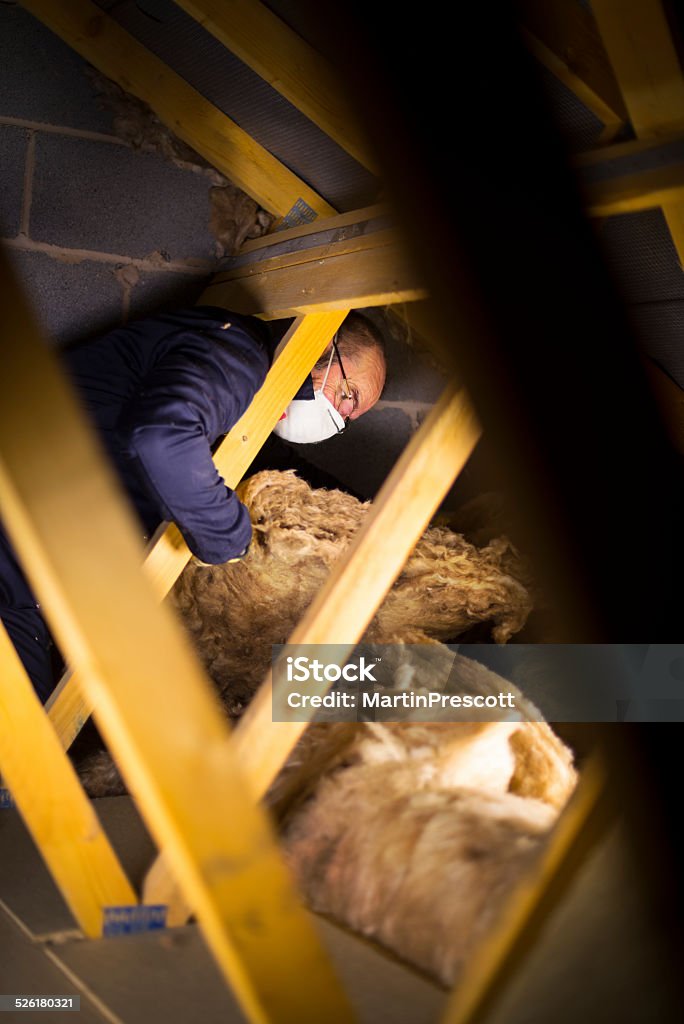 Hand putting wall insulation into a cabity wall